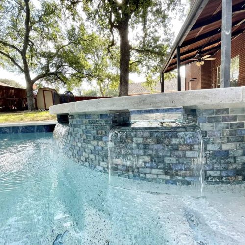 Travertine pool deck creates resort feel in Denton County 75033