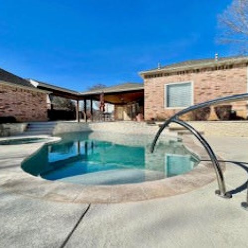 Travertine pool deck creates resort feel in Denton County 75034