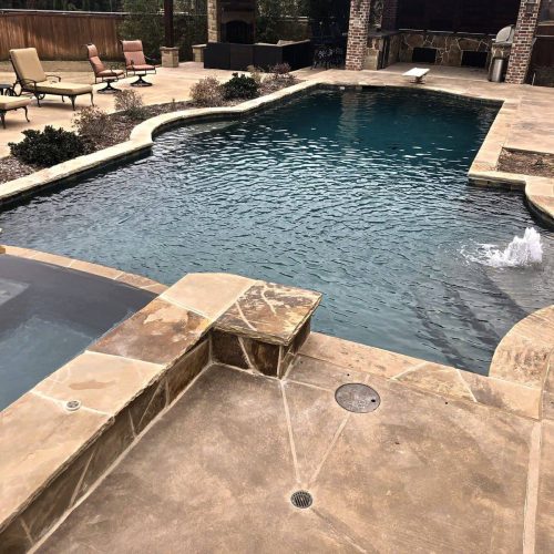 Inviting pool deck with travertine pavers in Frisco 75033