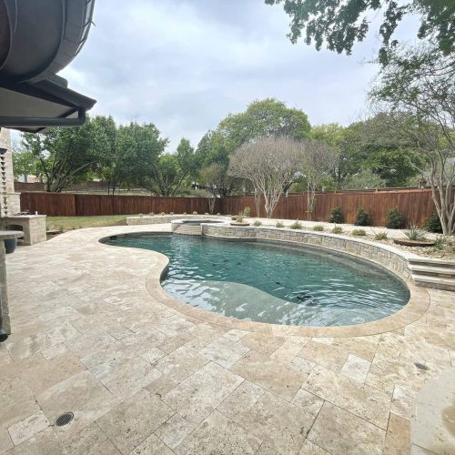 Inviting pool deck with travertine pavers in North Lake 76247