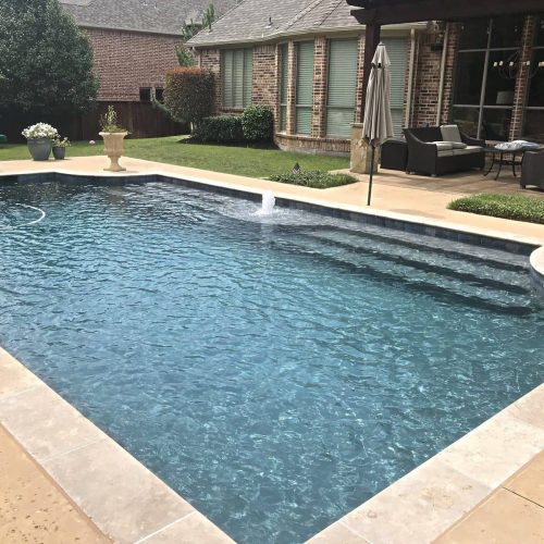Inviting pool deck with travertine pavers in North Lake 76226
