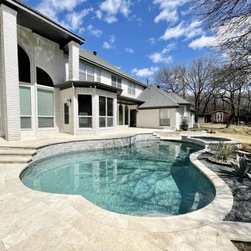 Inviting pool deck with travertine pavers in Denton County 75034
